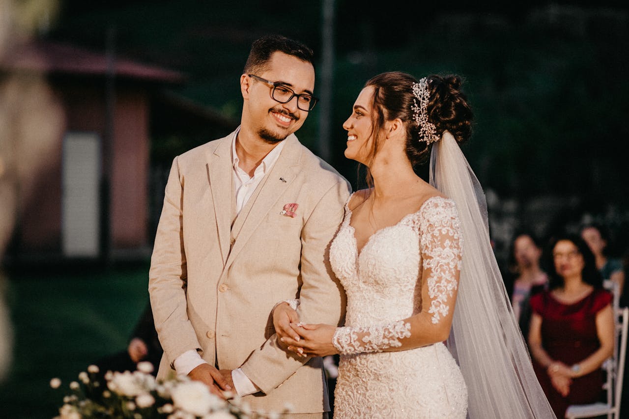 A happy couple sharing a loving moment during their outdoor wedding ceremony.